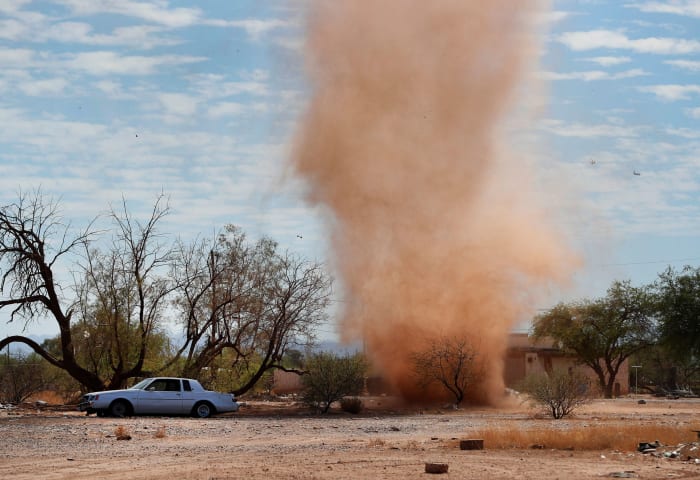 Dust devils form when a pocket of hot air from the ground rises quickly through cooler air above it, forming an updraft.